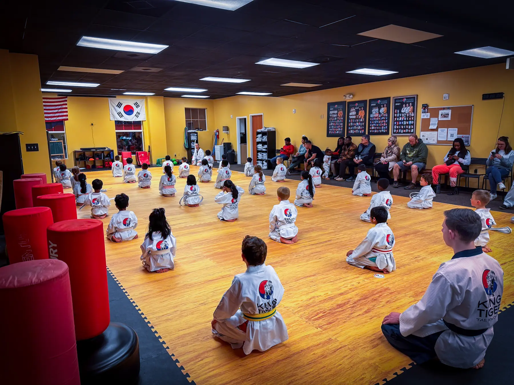King Tiger students seated for class while families watch at the Harrisburg academy